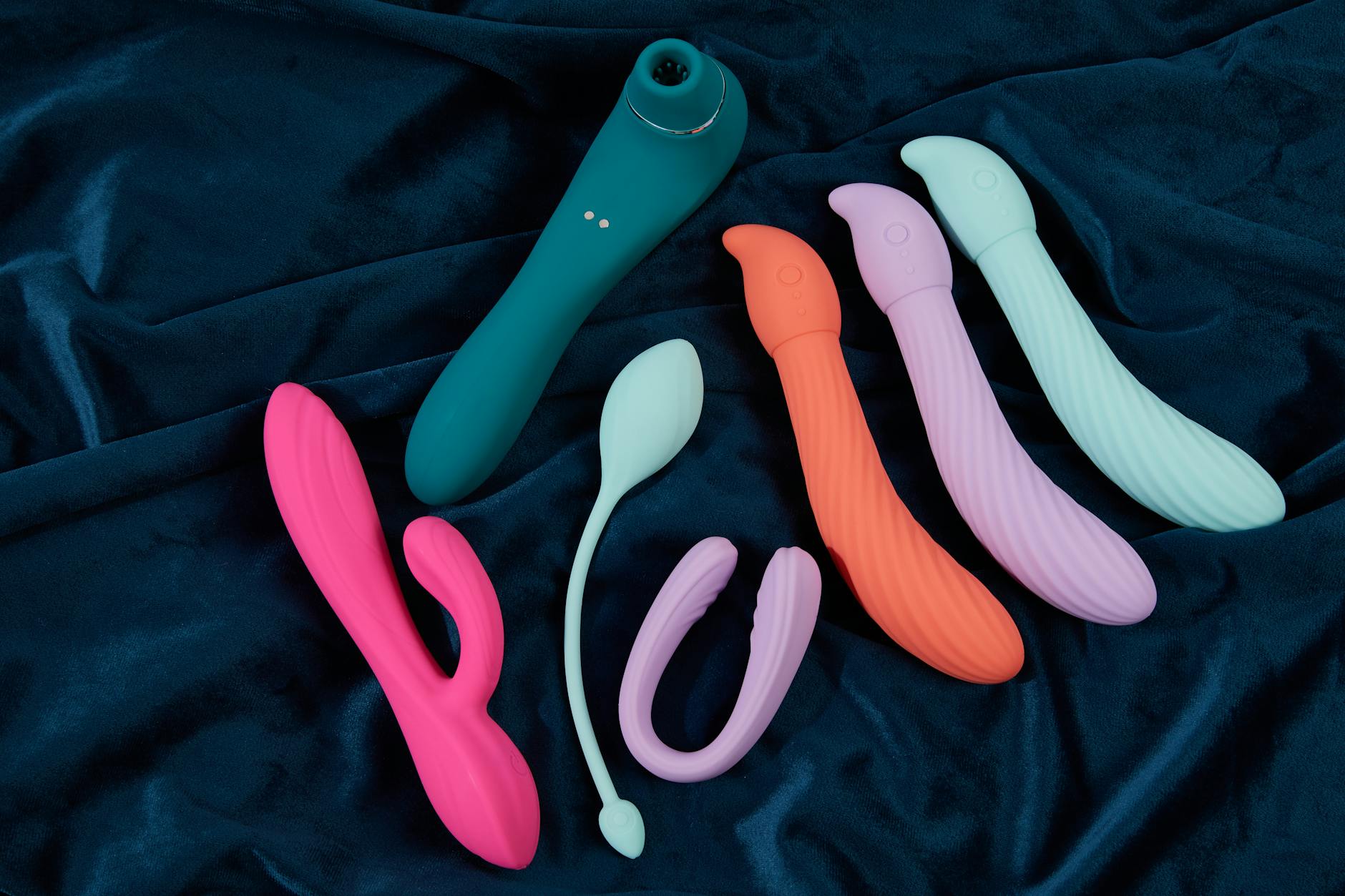 Yellow silicone vibrator surrounded by peeled bananas on a yellow background