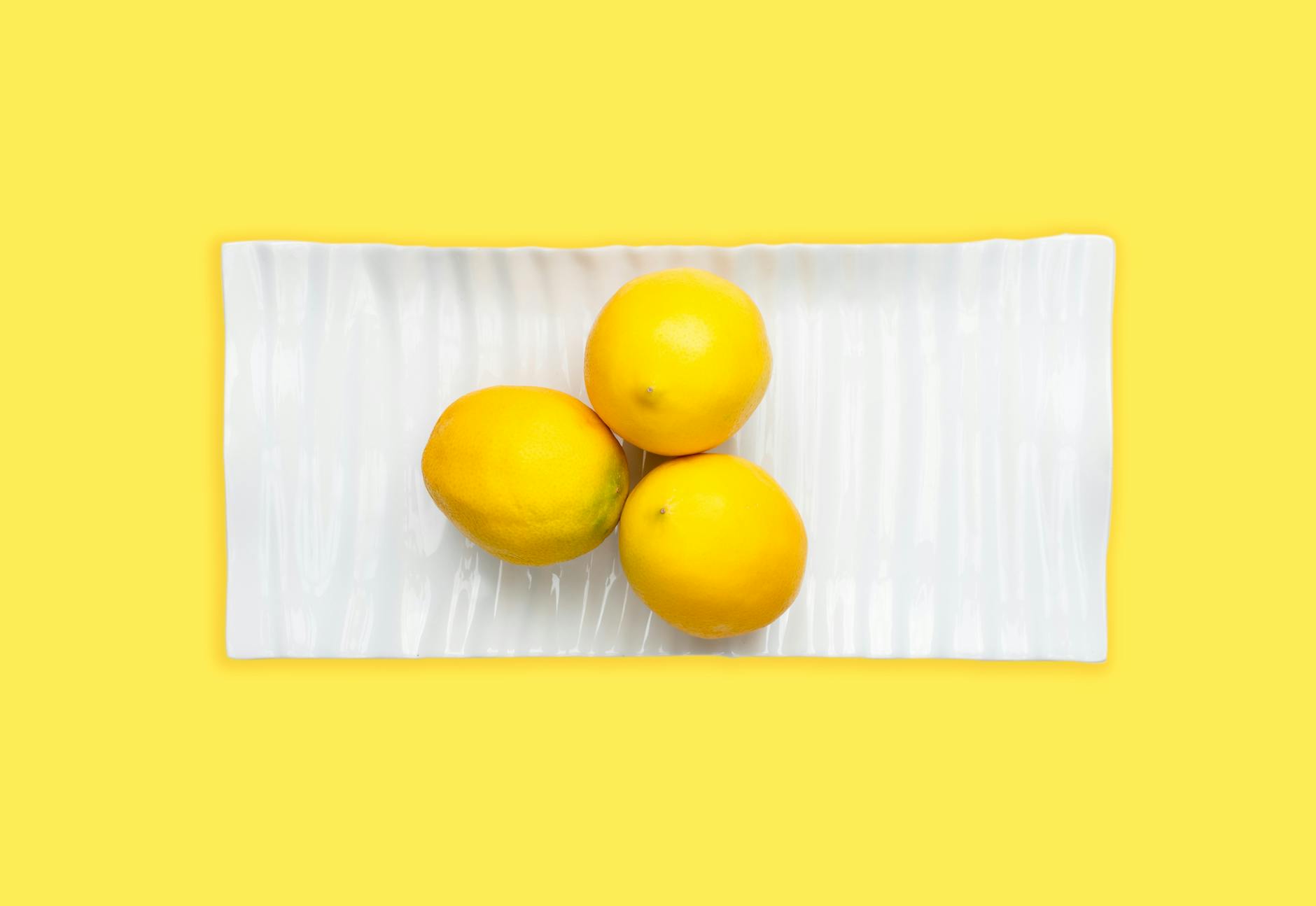 Fresh yellow lemons on a soft green background representing renewal and vitality during life transitions