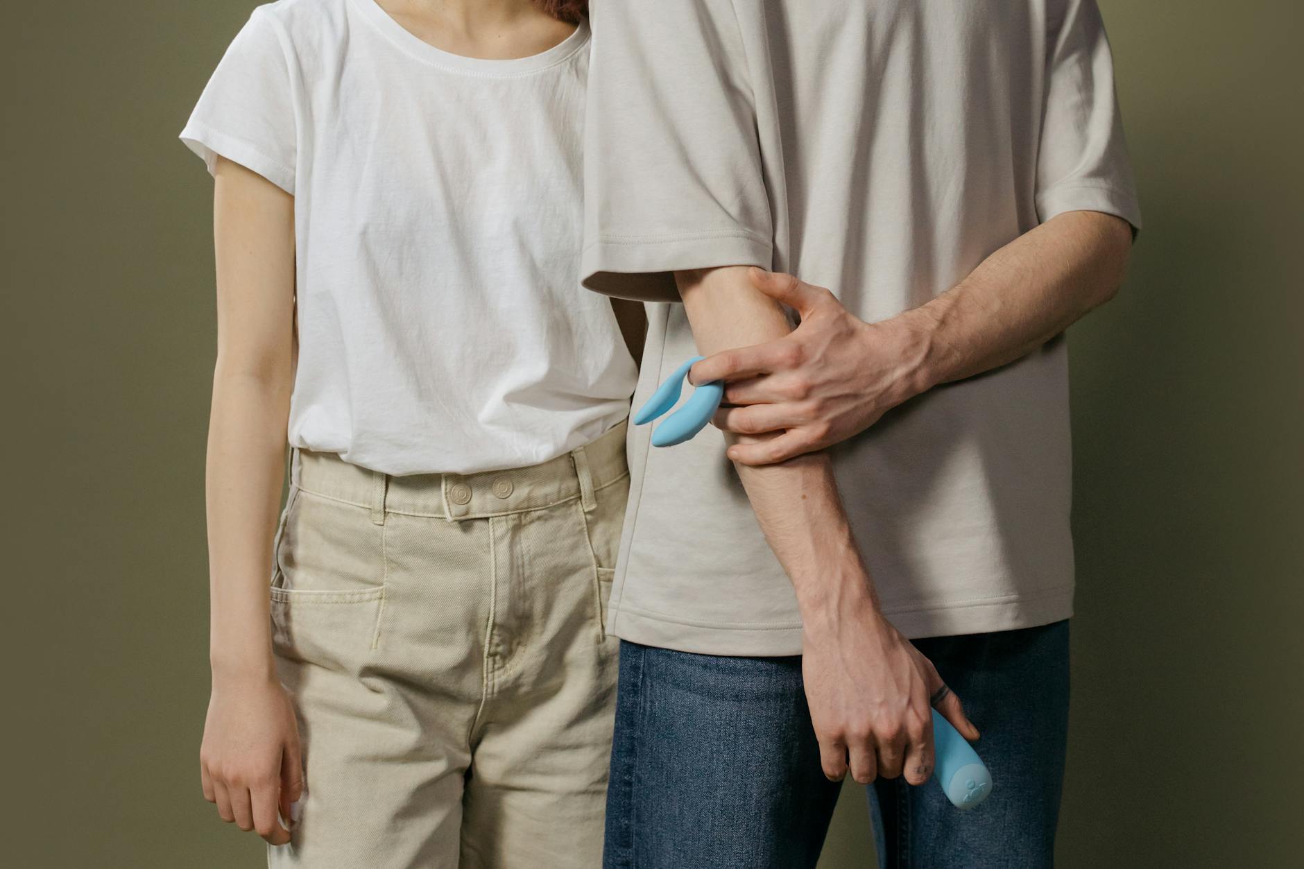 A person holds a vibrator in their hand, representing solo exploration and modern pleasure.